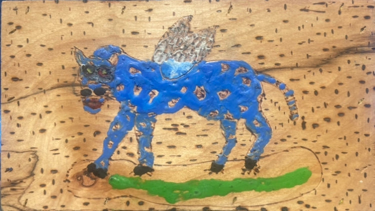 Blue creature with wings on a textured wood background